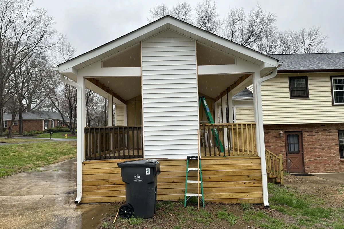 Existing porch structure before vinyl film enclosure installation in Charlotte